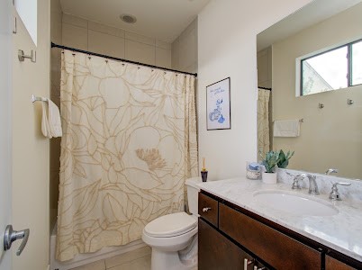 4510 Maxie Street, Unit B Houston, TX 77007 - Photo 2 of 39 a bathroom with a granite countertop sink toilet and shower