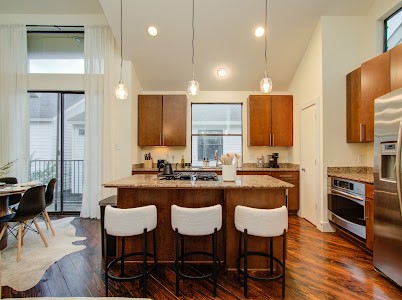 4510 Maxie Street, Unit B Houston, TX 77007 - Photo 22 of 39 a kitchen with granite countertop a sink and chairs