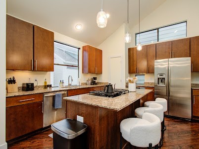 4510 Maxie Street, Unit B Houston, TX 77007 - Photo 23 of 39 a kitchen with stainless steel appliances granite countertop a sink refrigerator stove and microwave