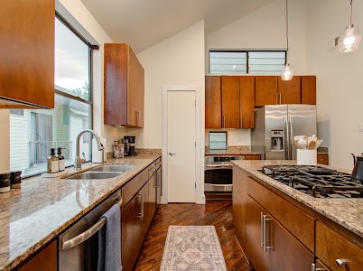 4510 Maxie Street, Unit B Houston, TX 77007 - Photo 24 of 39 a kitchen with granite countertop a sink stove and refrigerator