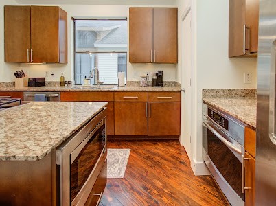 4510 Maxie Street, Unit B Houston, TX 77007 - Photo 25 of 39 a kitchen with stainless steel appliances granite countertop a stove a sink and a microwave