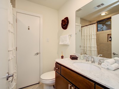 4510 Maxie Street, Unit B Houston, TX 77007 - Photo 33 of 39 a bathroom with a granite countertop sink a toilet and shower