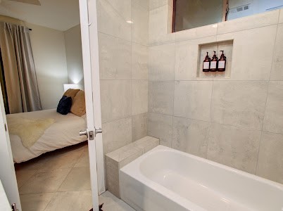 4510 Maxie Street, Unit B Houston, TX 77007 - Photo 34 of 39 a bathroom with a tub and a shower