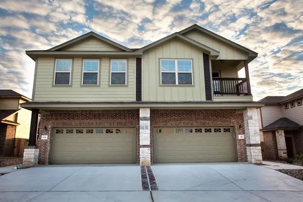 a front view of a house with a garage and a garage