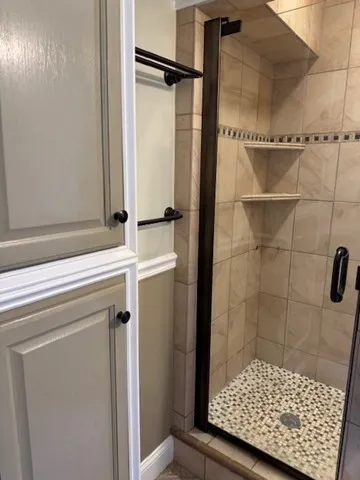 a bathroom with a shower and a sink