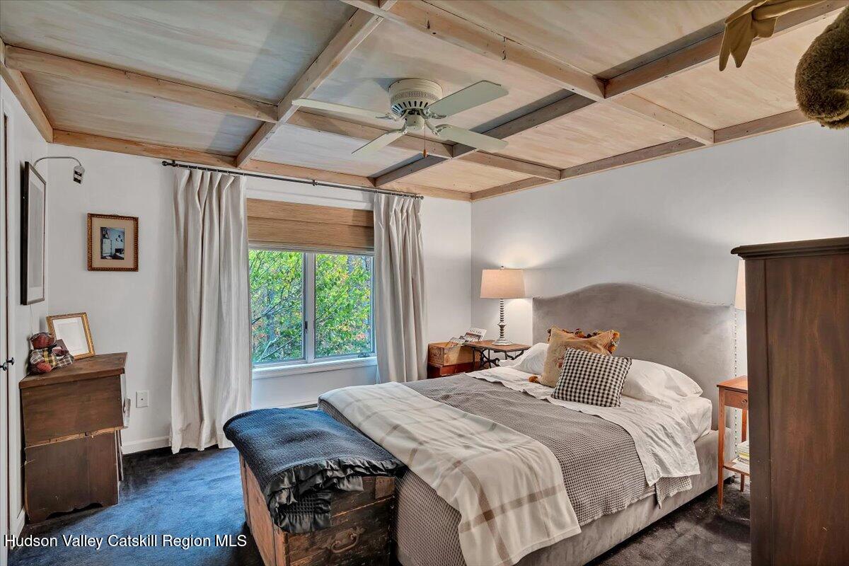 126 Storks Nest Road Round Top, NY 12473 - Photo 14 of 44 a bedroom with a bed and a table