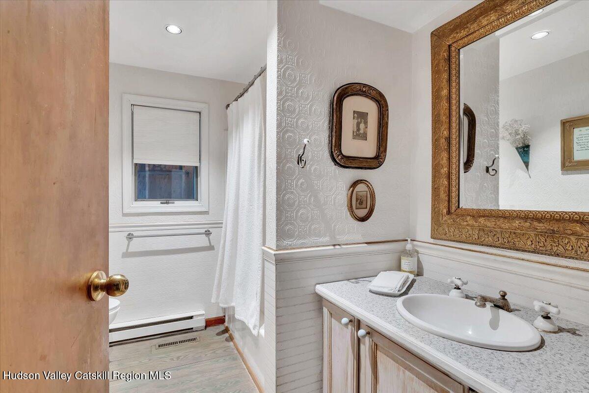 126 Storks Nest Road Round Top, NY 12473 - Photo 15 of 44 a bathroom with a granite countertop sink and a mirror