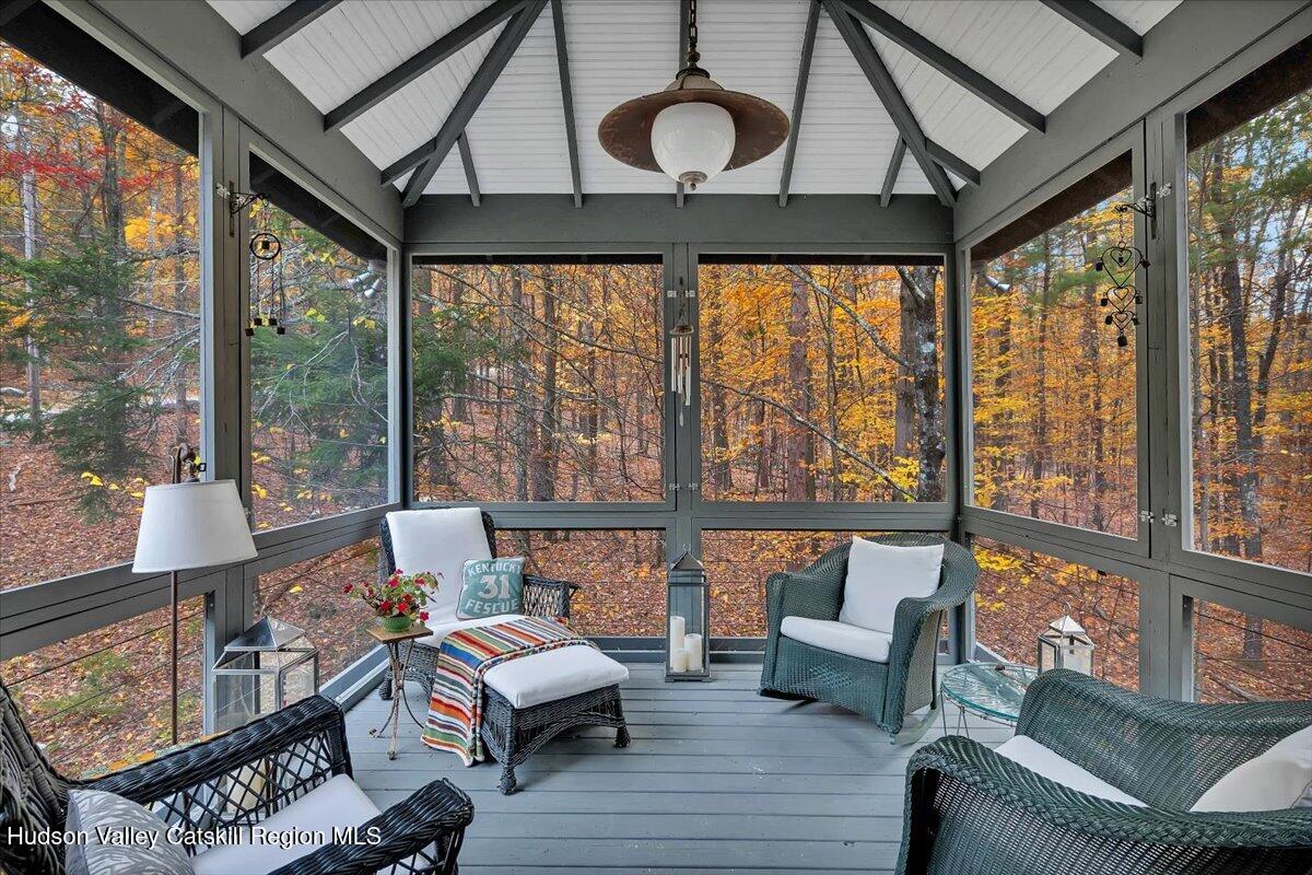 126 Storks Nest Road Round Top, NY 12473 - Photo 18 of 44 a living room with furniture and a floor to ceiling window