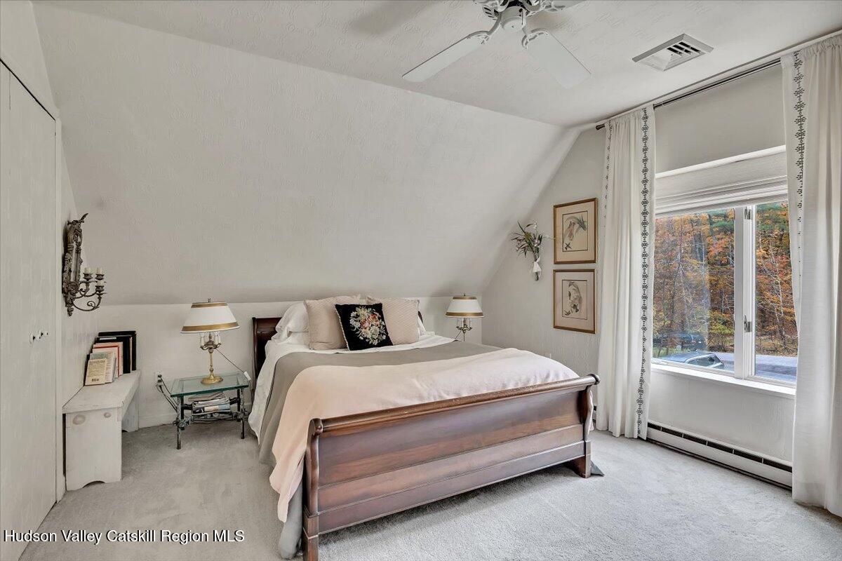 126 Storks Nest Road Round Top, NY 12473 - Photo 19 of 44 a bedroom with a bed and a walk in closet