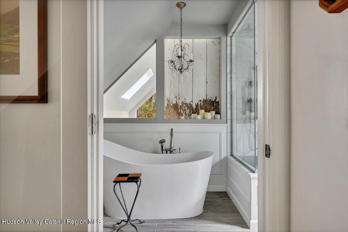 126 Storks Nest Road Round Top, NY 12473 - Photo 20 of 44 a bathroom with a bathtub and shower