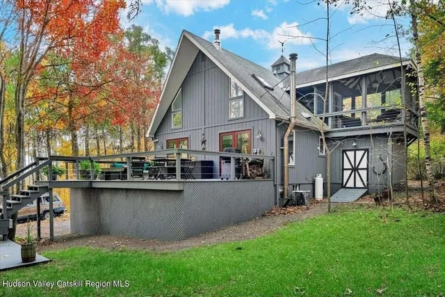 a front view of a house with garden and plants