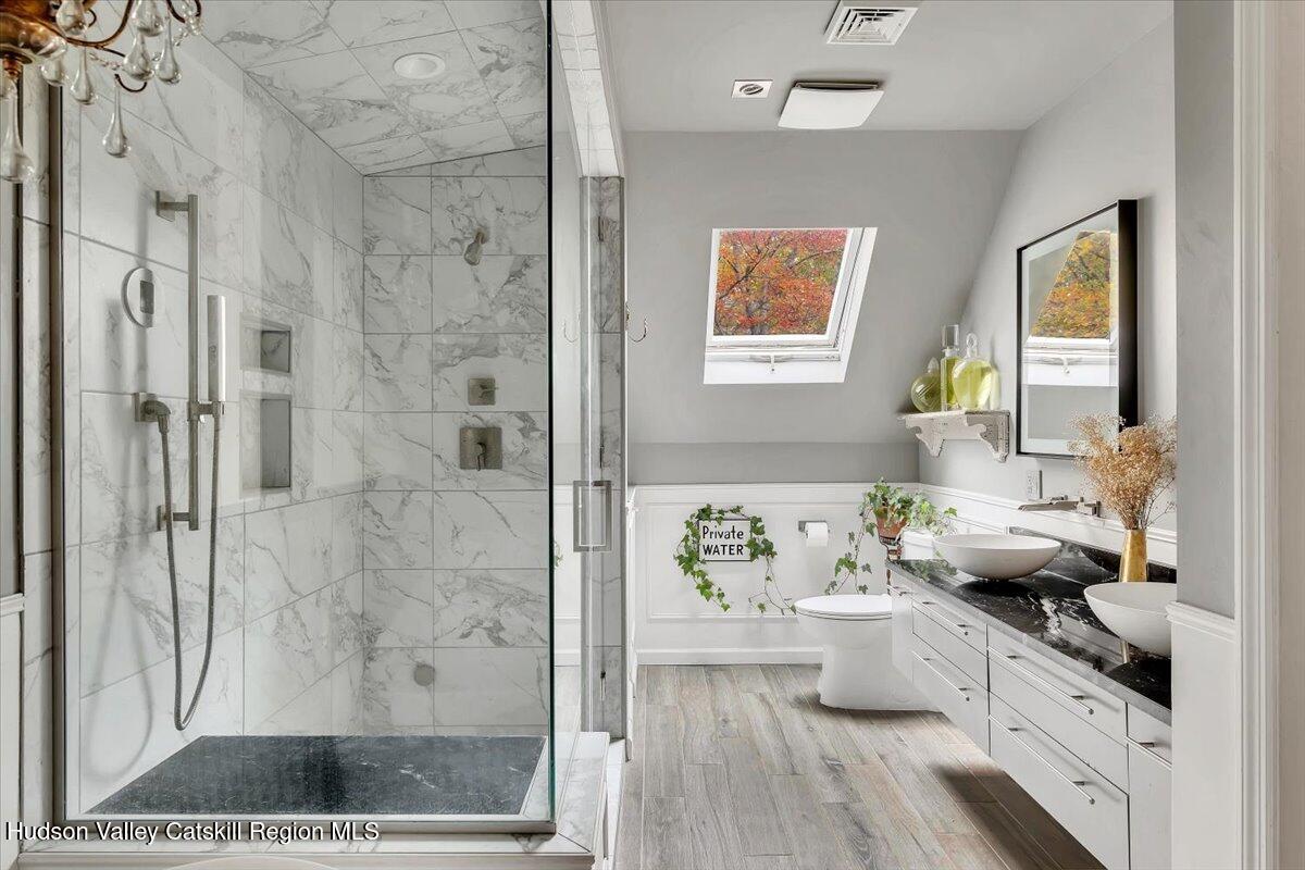 126 Storks Nest Road Round Top, NY 12473 - Photo 21 of 44 a view of a bathroom with tub and window