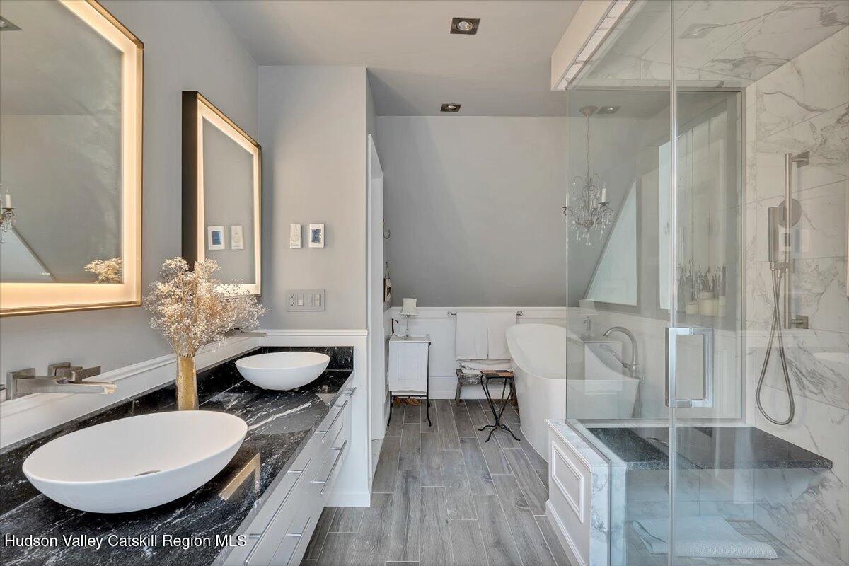 126 Storks Nest Road Round Top, NY 12473 - Photo 23 of 43 a bathroom with a granite countertop sink and a mirror