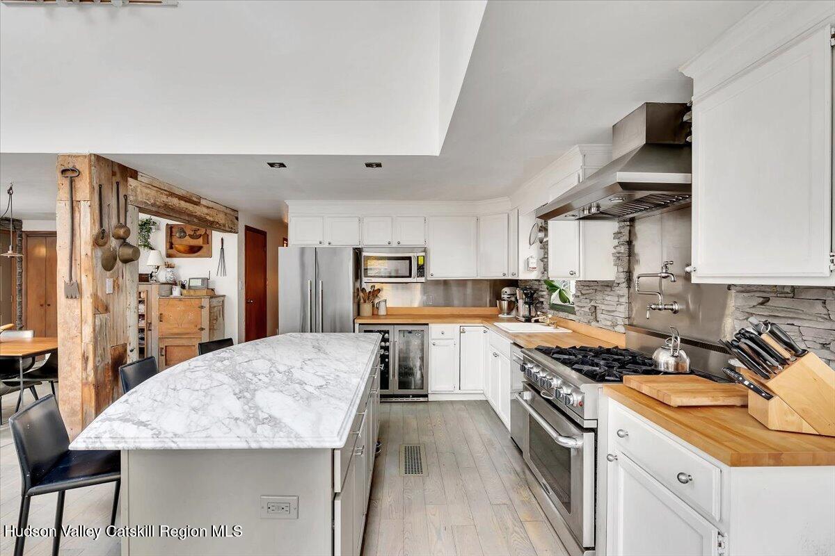 126 Storks Nest Road Round Top, NY 12473 - Photo 3 of 44 a kitchen with granite countertop a sink stove and refrigerator