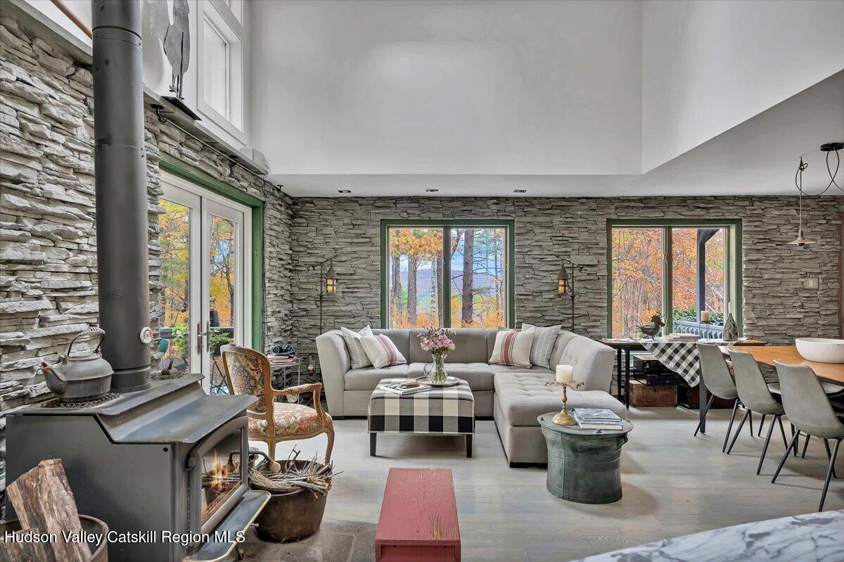 126 Storks Nest Road Round Top, NY 12473 - Photo 5 of 44 a living room with furniture and floor to ceiling windows