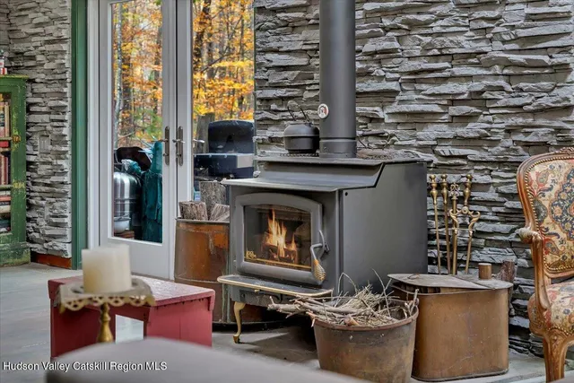 a kitchen with stainless steel appliances kitchen island a table chairs refrigerator and stove