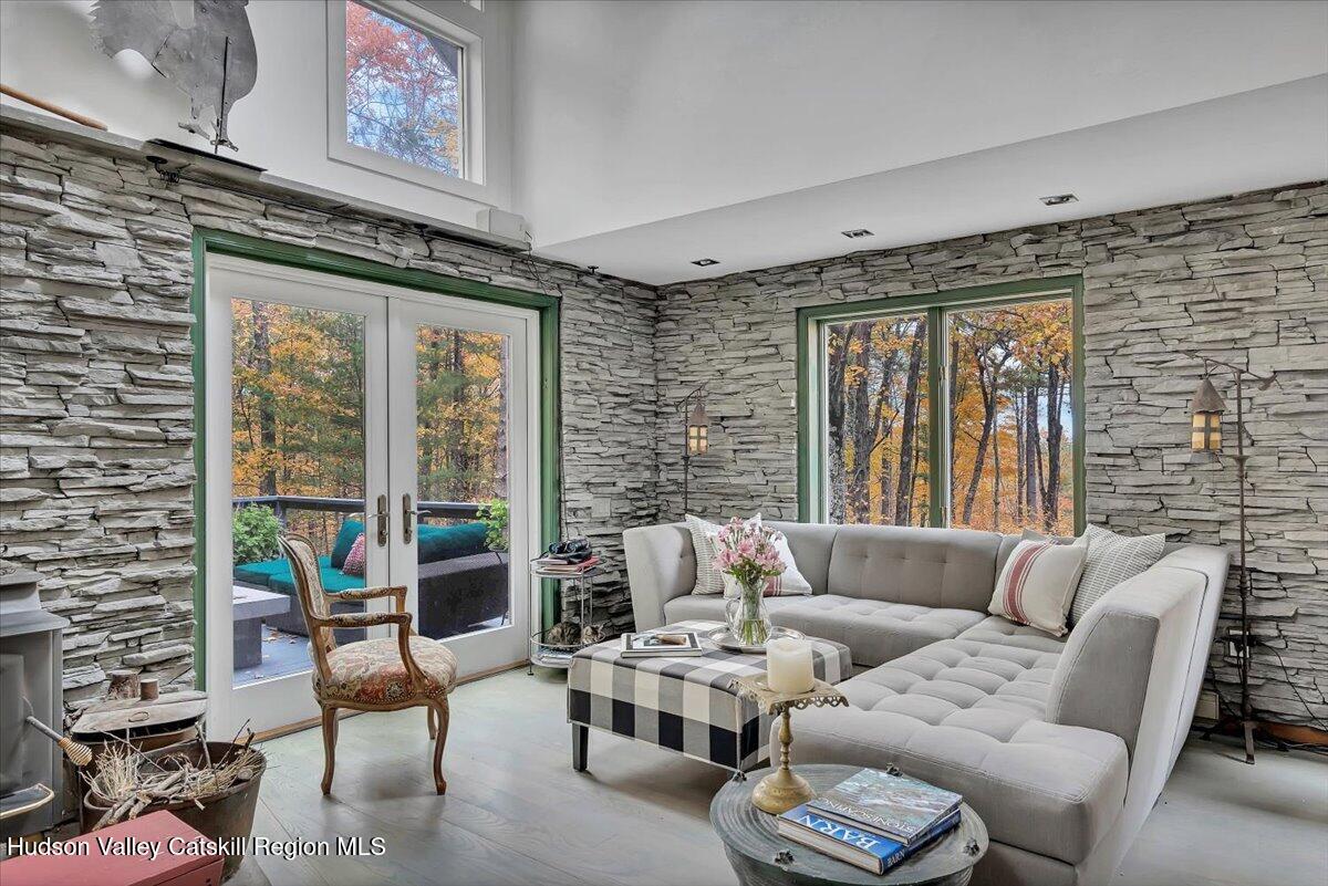 126 Storks Nest Road Round Top, NY 12473 - Photo 10 of 43 a living room with furniture and a large window