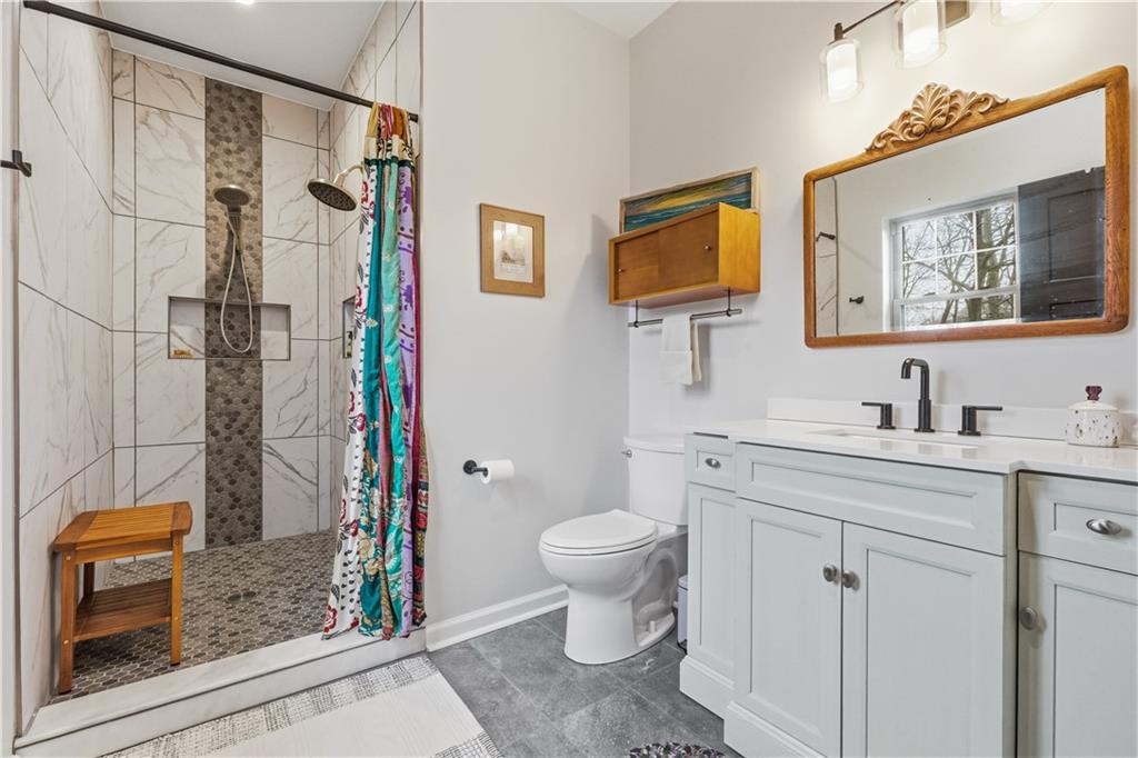 2388 Ridge Road Extension Ambridge, PA 15003 - Photo 24 of 44 a bathroom with a shower sink vanity mirror and toilet