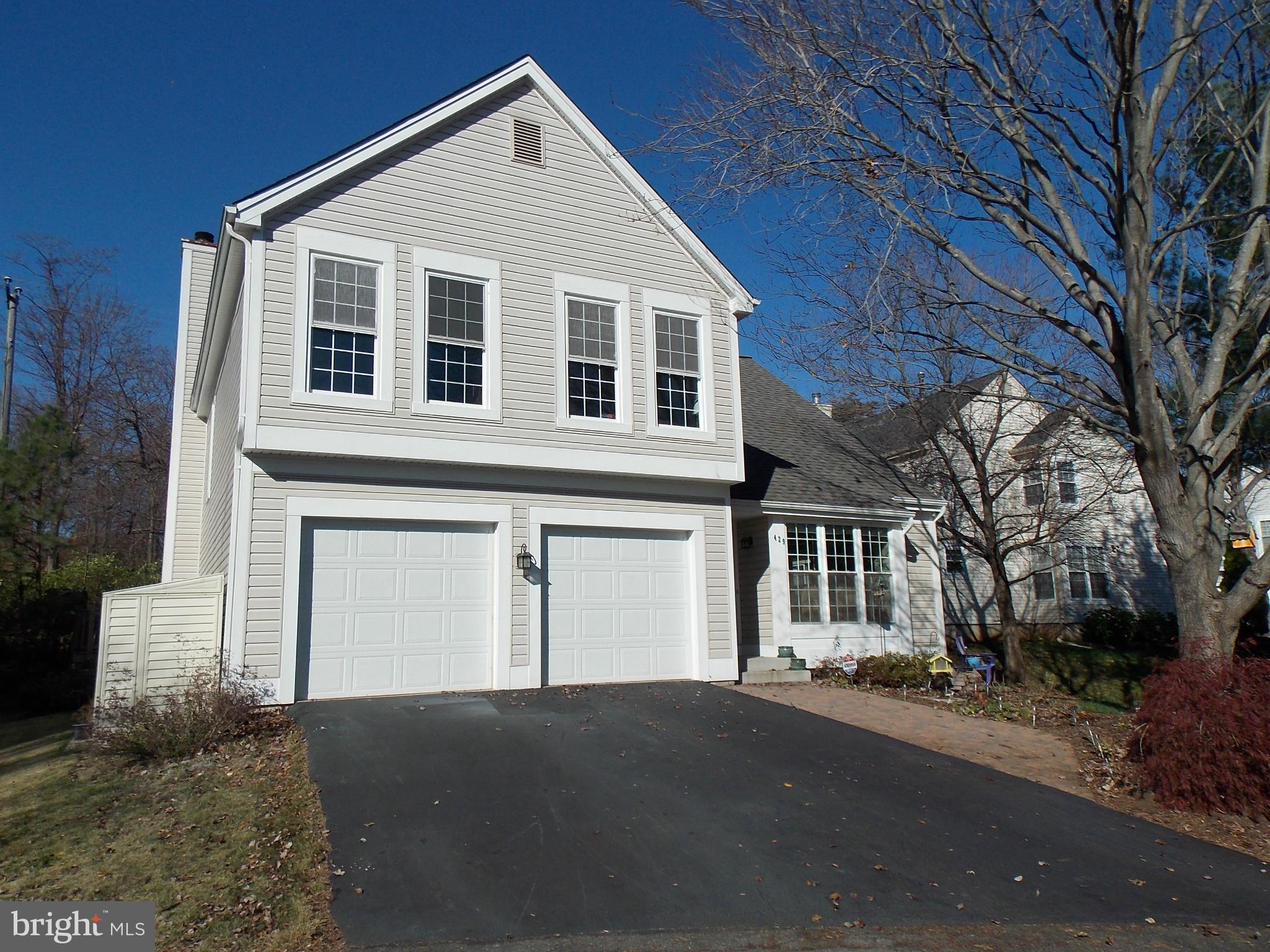 429 Deer Path Avenue Southwest Leesburg, VA 20175 - Photo 1 of 30 a front view of a house with a yard and garage