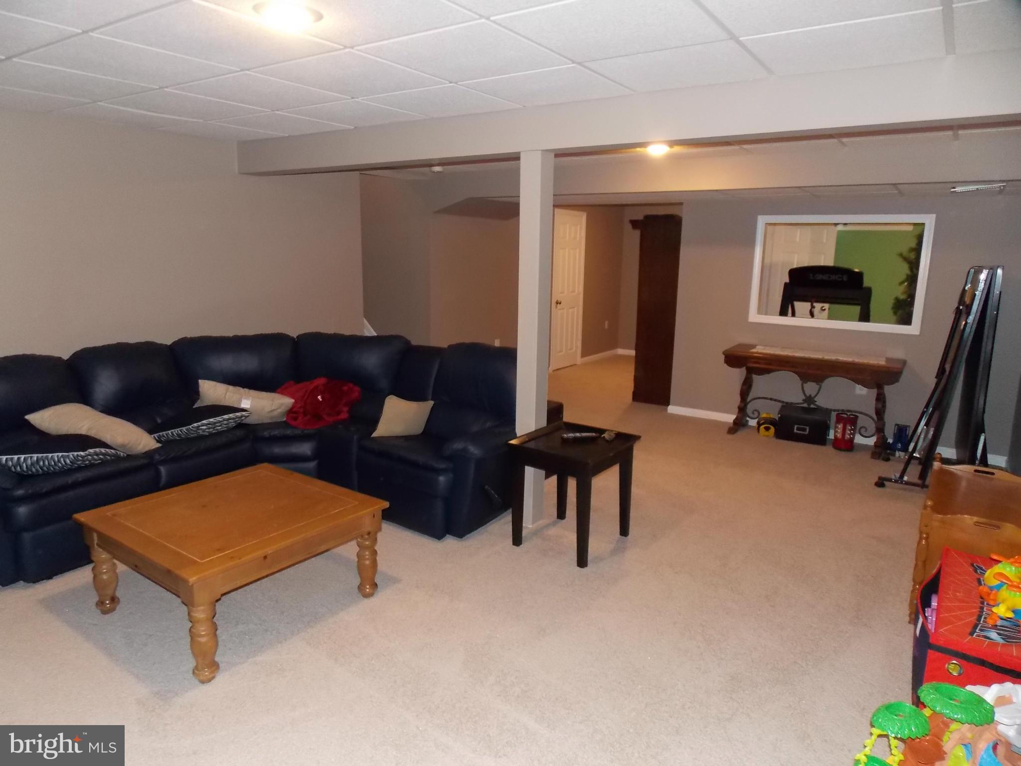 429 Deer Path Avenue Southwest Leesburg, VA 20175 - Photo 23 of 30 a living room with furniture and a flat screen tv