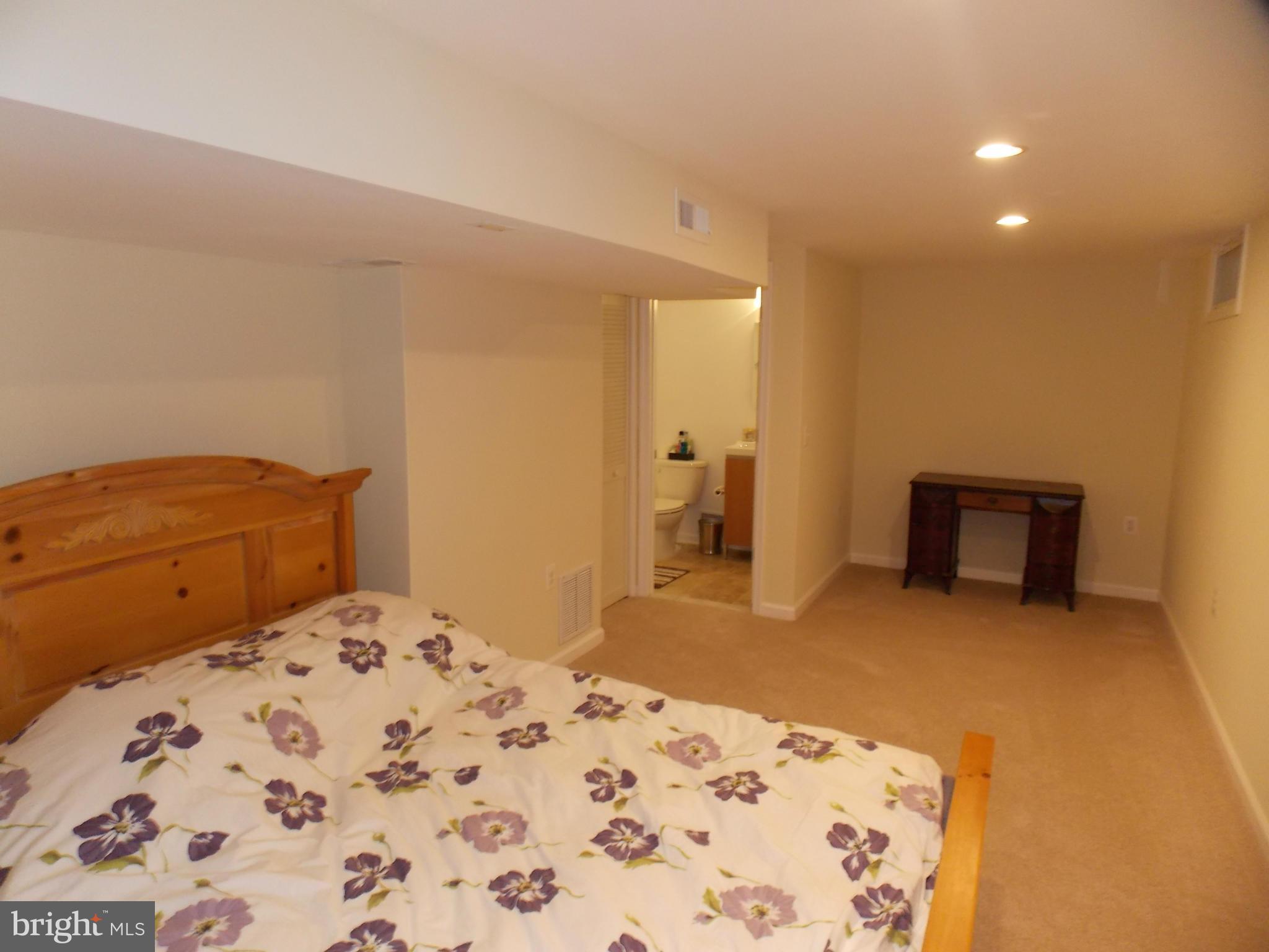 429 Deer Path Avenue Southwest Leesburg, VA 20175 - Photo 28 of 30 a bedroom with a bed and a lamp