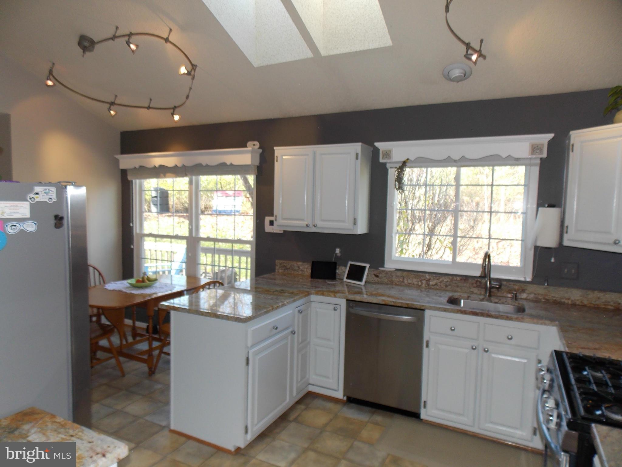 429 Deer Path Avenue Southwest Leesburg, VA 20175 - Photo 7 of 30 a kitchen that has a sink and a stove in it
