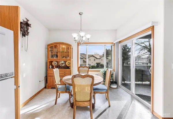 a dining room with furniture a chandelier and window