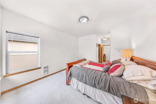 a bedroom with two beds and a window