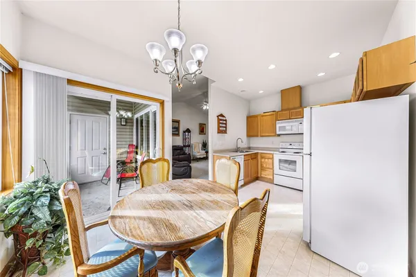 a view of a dining room with furniture and a chandelier