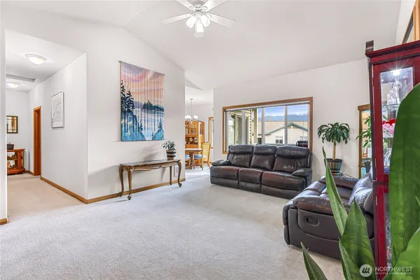 a living room with furniture and a potted plant