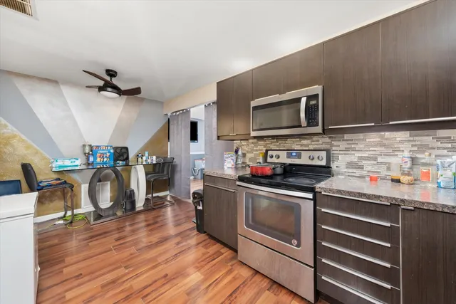 a kitchen with stainless steel appliances granite countertop a stove and a microwave