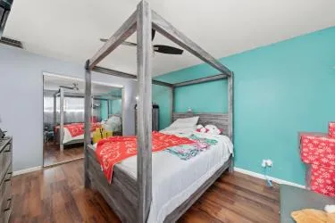 a bedroom with a bed and wooden floor