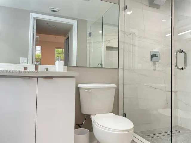 a bathroom with a toilet a sink and shower