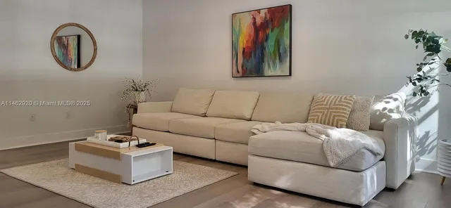 a living room with furniture and a potted plant
