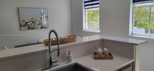 a bathroom with a sink and a window