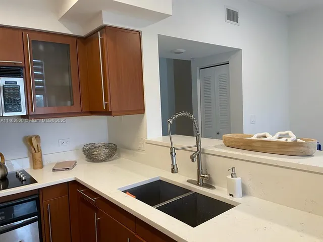 a kitchen with a sink and cabinets