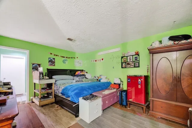 a bed room with a bed and a tv