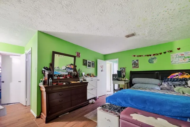 a bedroom with furniture and a baby crib