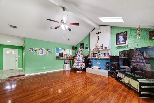 a living room filled with furniture and a wooden floor