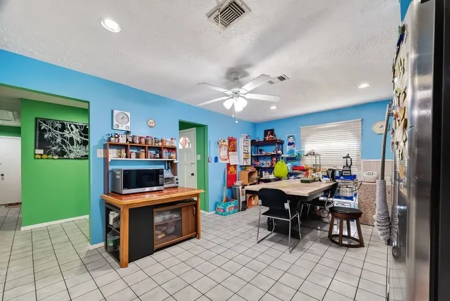 a room with furniture a ceiling fan and a wooden floor