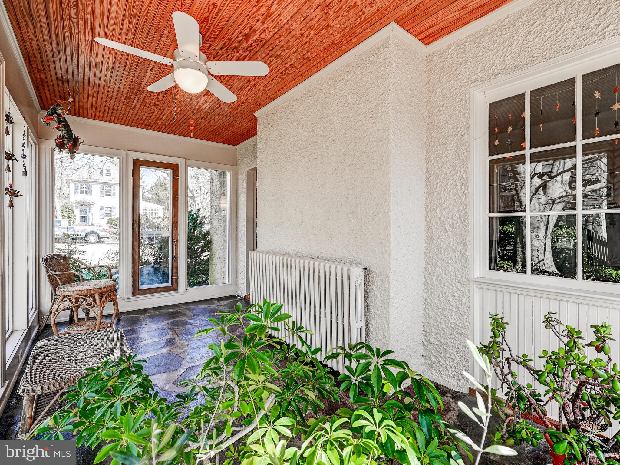 207 Cedarcroft Road Baltimore, MD 21212 - Photo 11 of 50 a view of a porch with a floor to ceiling window and wooden floor