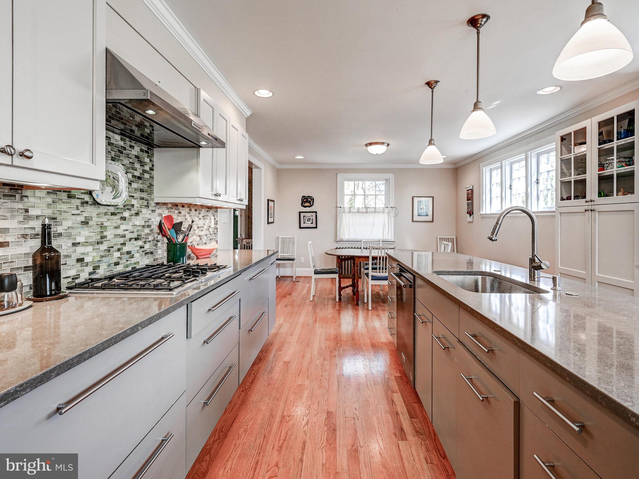 207 Cedarcroft Road Baltimore, MD 21212 - Photo 19 of 50 a large kitchen with stainless steel appliances granite countertop a lot of counter space and wooden floors