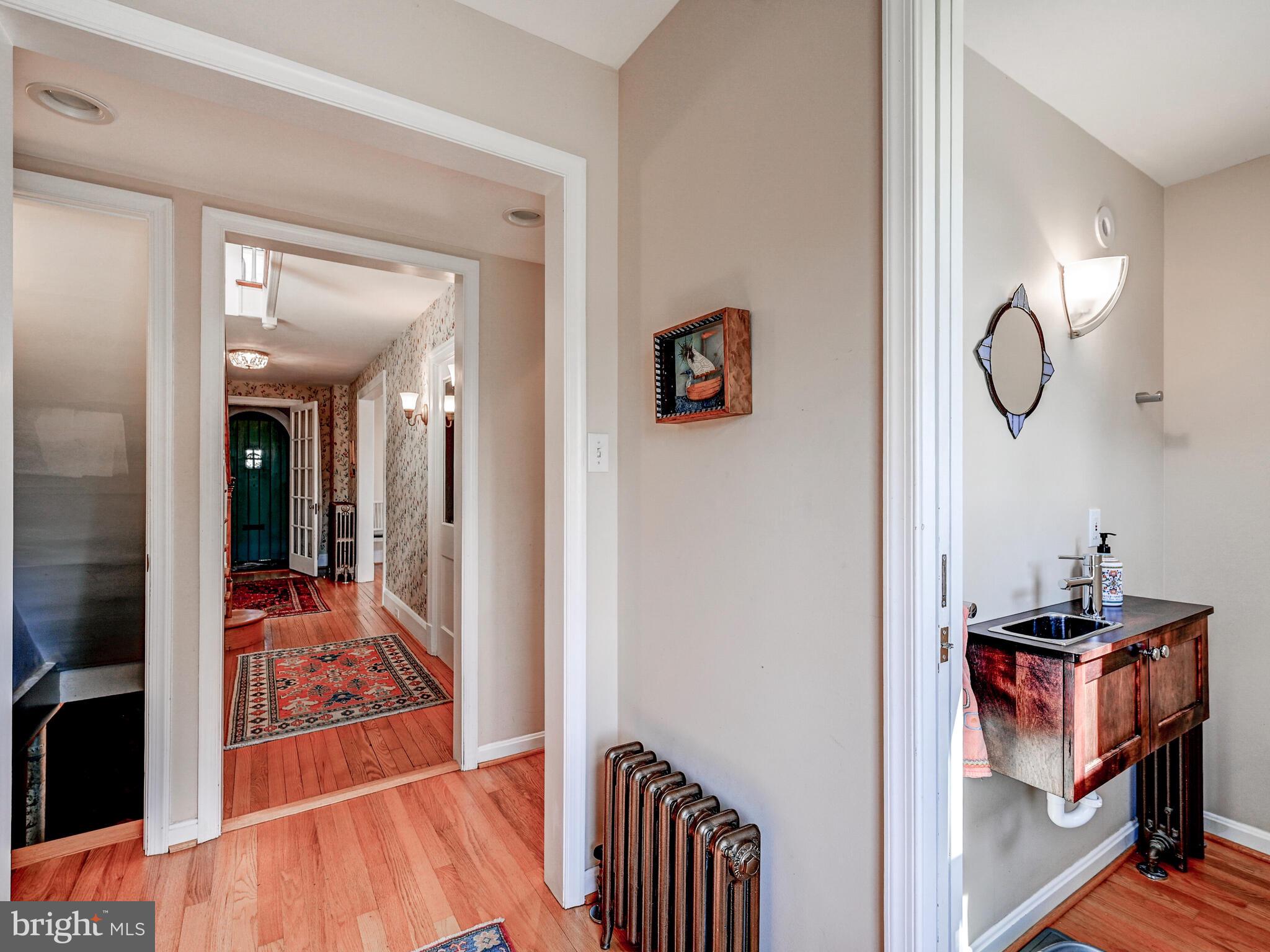 207 Cedarcroft Road Baltimore, MD 21212 - Photo 22 of 50 a view of a hallway and a dining room with wooden floor