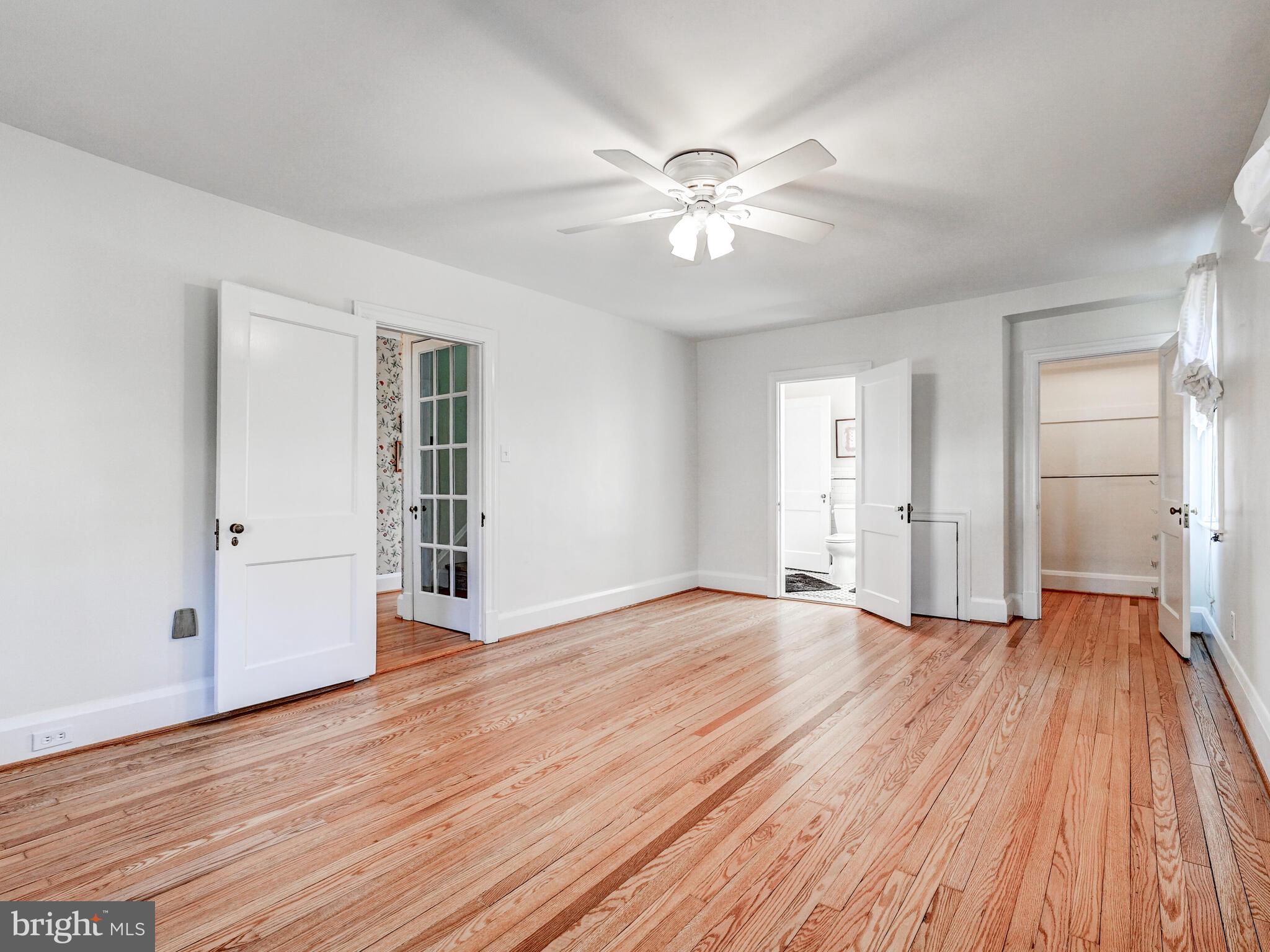 207 Cedarcroft Road Baltimore, MD 21212 - Photo 26 of 50 a view of empty room with wooden floor and fan