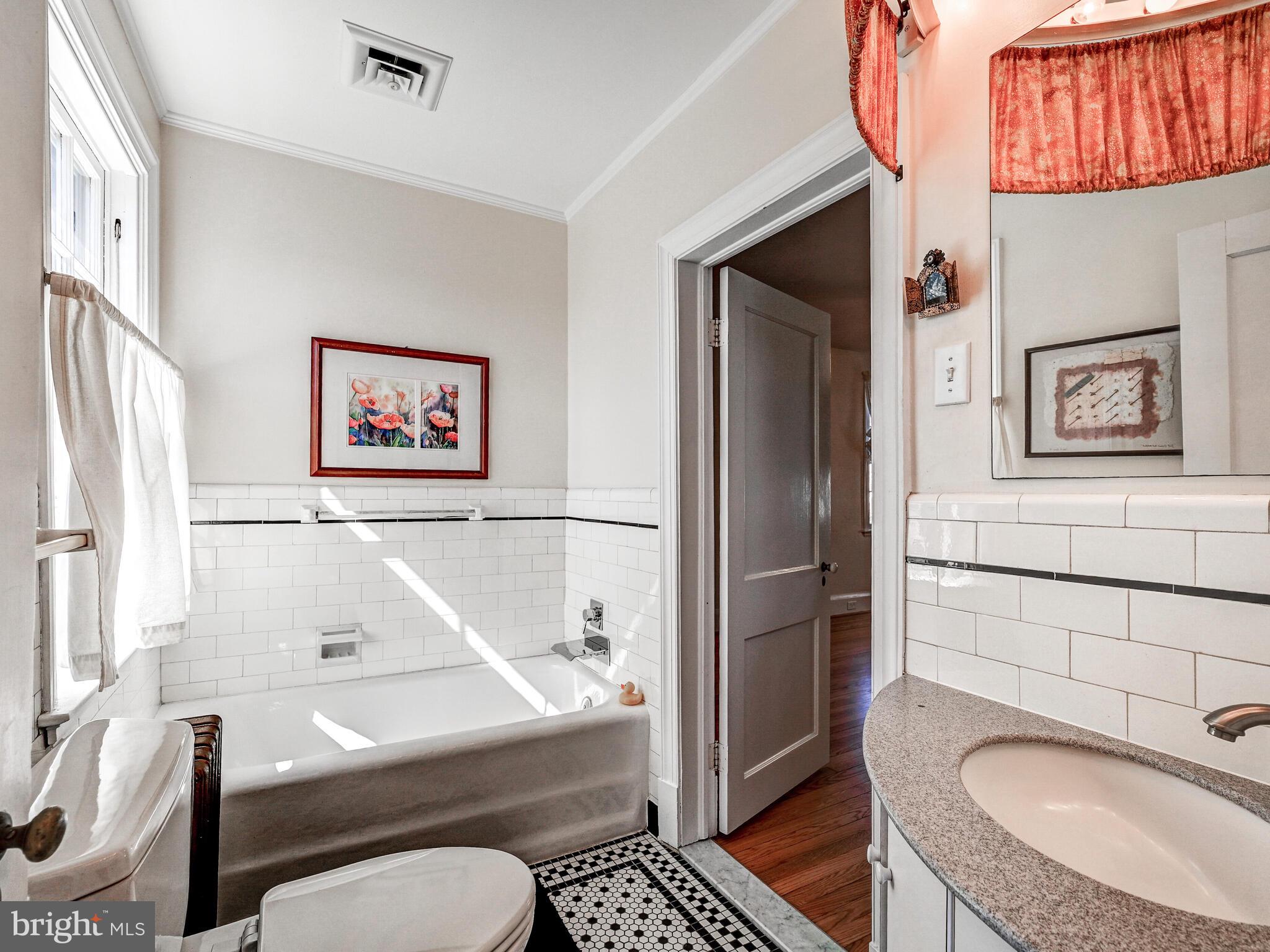 207 Cedarcroft Road Baltimore, MD 21212 - Photo 27 of 50 a bathroom with a sink toilet and shower