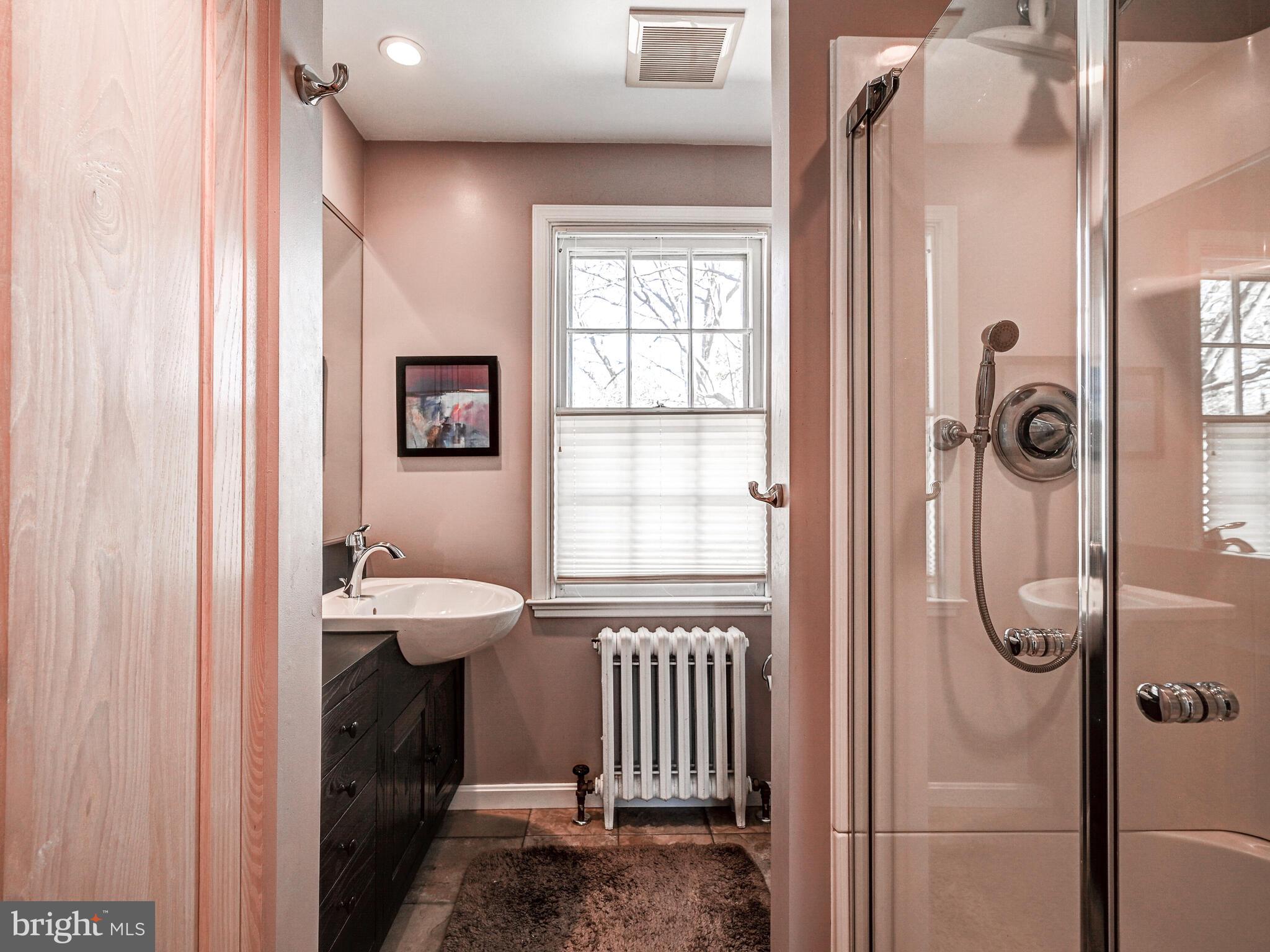 207 Cedarcroft Road Baltimore, MD 21212 - Photo 30 of 50 a bathroom with a sink a mirror a toilet and shower