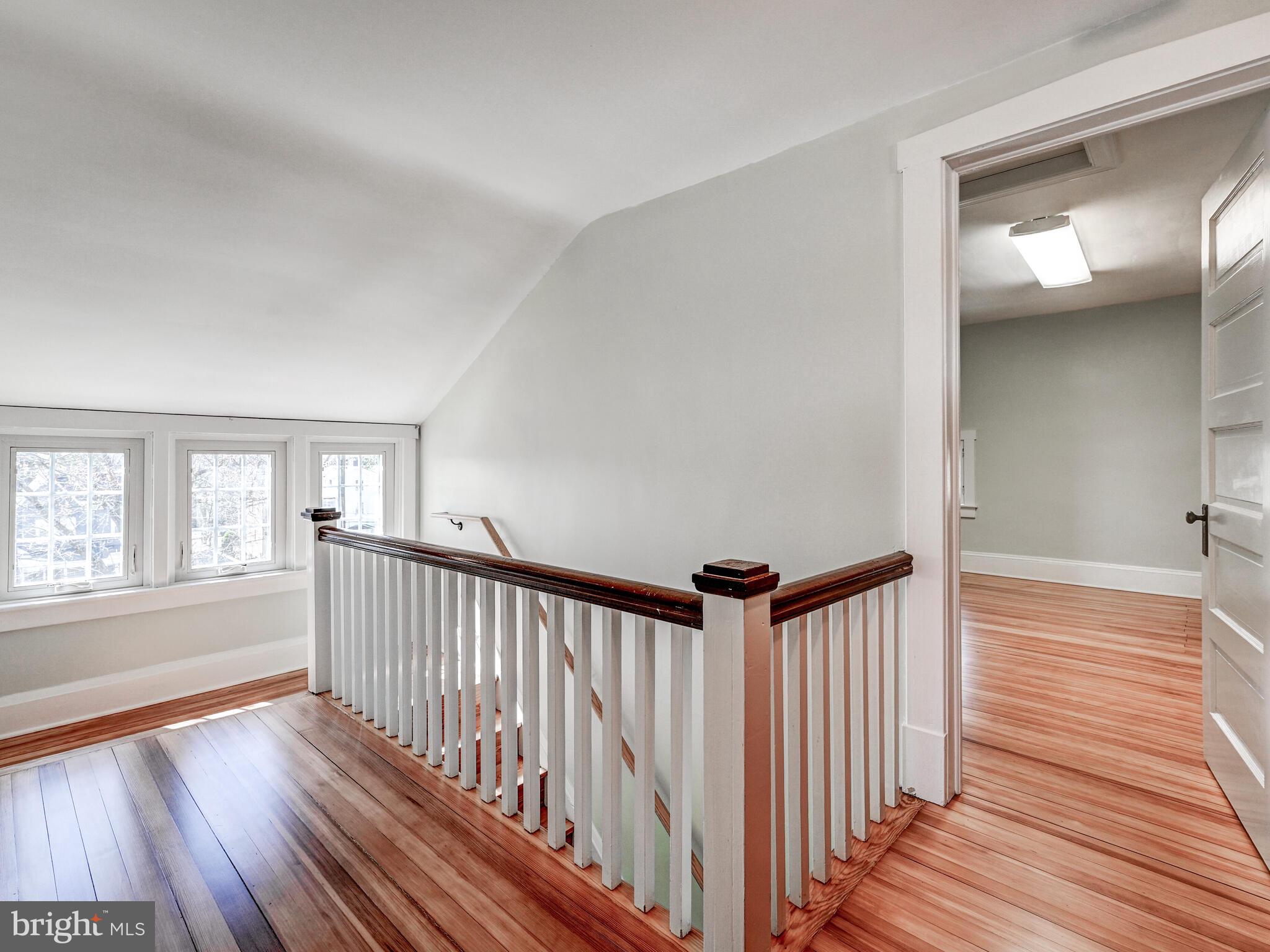 207 Cedarcroft Road Baltimore, MD 21212 - Photo 33 of 50 a view of a hallway with wooden floor and windows