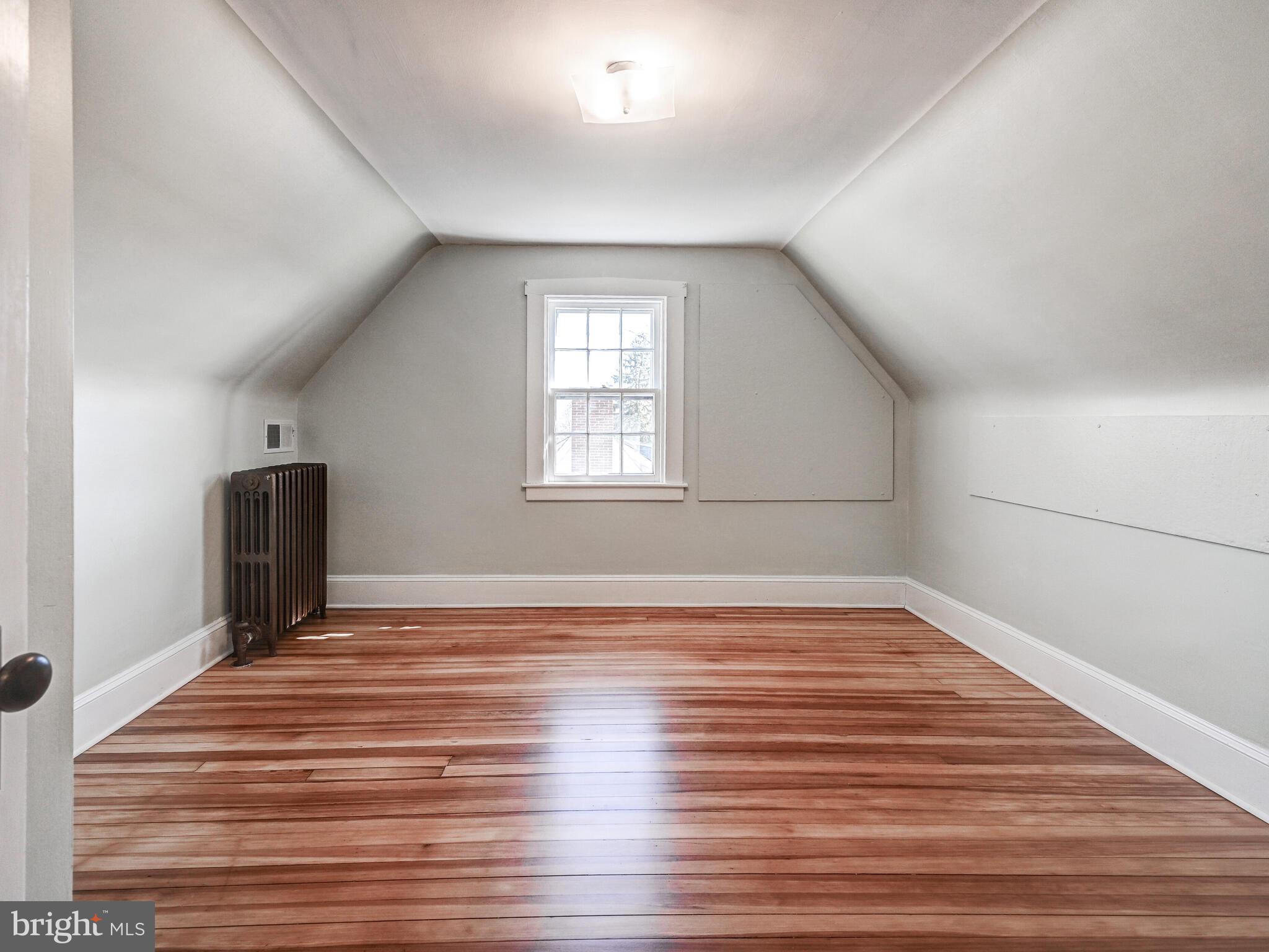 207 Cedarcroft Road Baltimore, MD 21212 - Photo 35 of 50 a view of empty room with wooden floor and fan