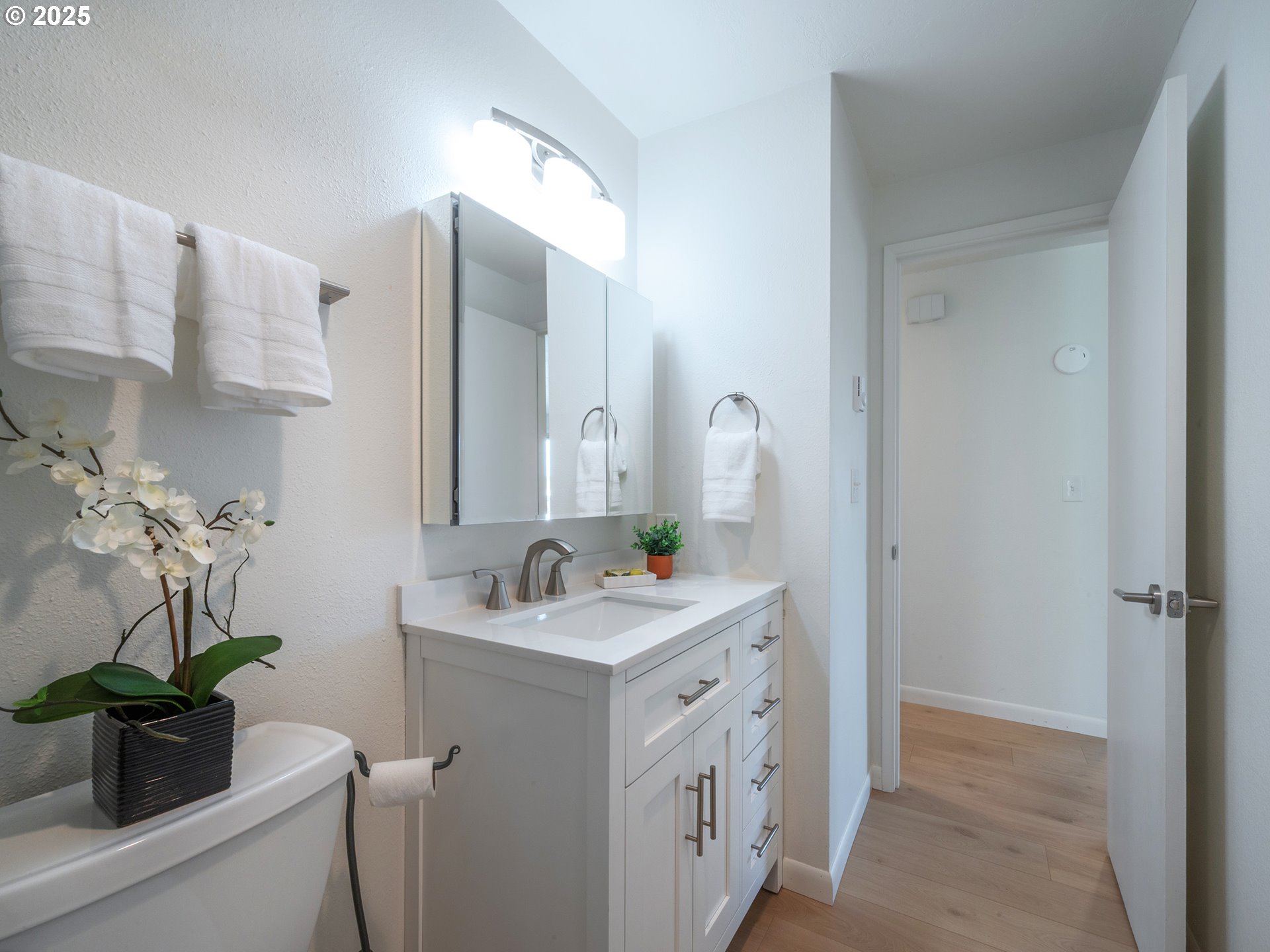 1376 Buck Street Eugene, OR 97402 - Photo 19 of 31 a bathroom with a sink a potted plant and a mirror