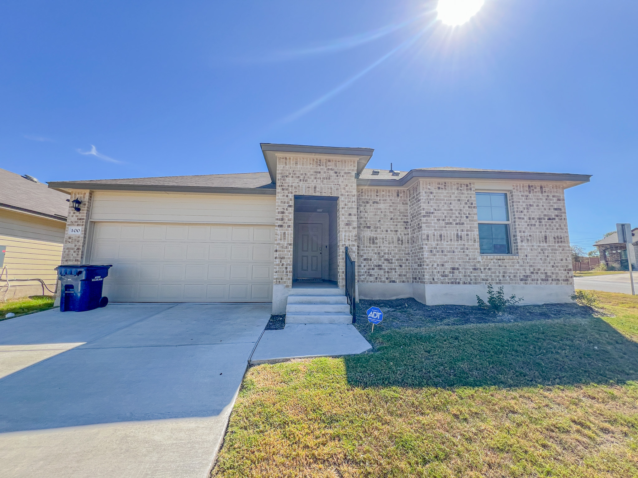 100 Taggart Trail Jarrell, TX 76537 - Photo 2 of 18 View of front of property with brick siding, concrete driveway, and a front yard